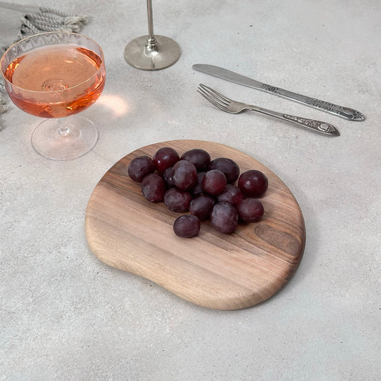 Zeep Naturals | Carya Collection Amorphous Walnut Curved Serving & Presentation Board | Zeep Naturals brings you handcrafted soaps, organic cotton towels, and artisan kitchen essentials — all inspired by nature. Discover simple, sustainable living with products designed to soothe your senses and your home.