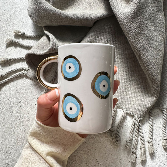 Zeep Naturals | White Ceramic Evil Eye Coffee/Tea Cups | Catskills-inspired artisan natural soaps, luxurious Turkish towels, bathrobes, throws, and bedding. Discover handmade coffee cups, milk dispensers, and olive wood kitchen utensils—crafted with care for your home