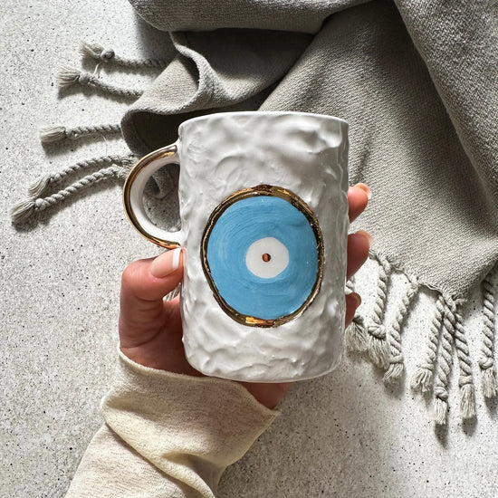 Zeep Naturals | White Ceramic Eternal Eye Coffee/Tea Cups | Catskills-inspired artisan natural soaps, luxurious Turkish towels, bathrobes, throws, and bedding. Discover handmade coffee cups, milk dispensers, and olive wood kitchen utensils—crafted with care for your home