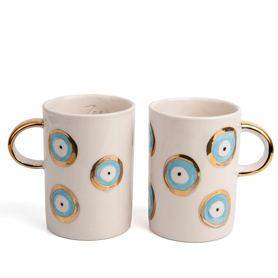 Zeep Naturals | White Ceramic Evil Eye Coffee/Tea Cups | Catskills-inspired artisan natural soaps, luxurious Turkish towels, bathrobes, throws, and bedding. Discover handmade coffee cups, milk dispensers, and olive wood kitchen utensils—crafted with care for your home